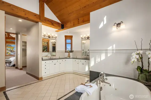 Light & bright en suite 5-piece bathroom with jetted, soaking tub and oversized walk-in shower with pebble stone flooring. A wall of closets plus large walk-in closet complete the primary suite.