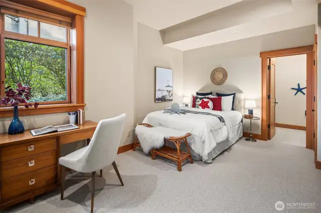 Private, large bedroom with spacious en suite 3/4 bath & custom built-in cabinetry.