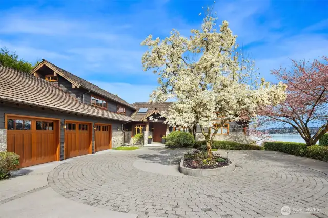 A level, circular courtyard with abundant guest parking and three-car garage ensures both privacy and convenience.