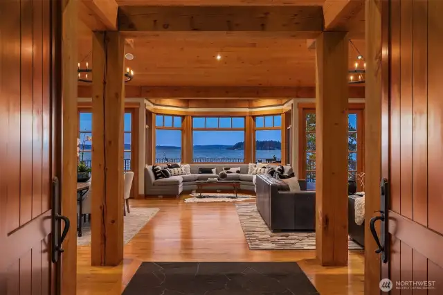 Step inside the vaulted great room, where floor-to-ceiling windows frame stunning lake and city views.