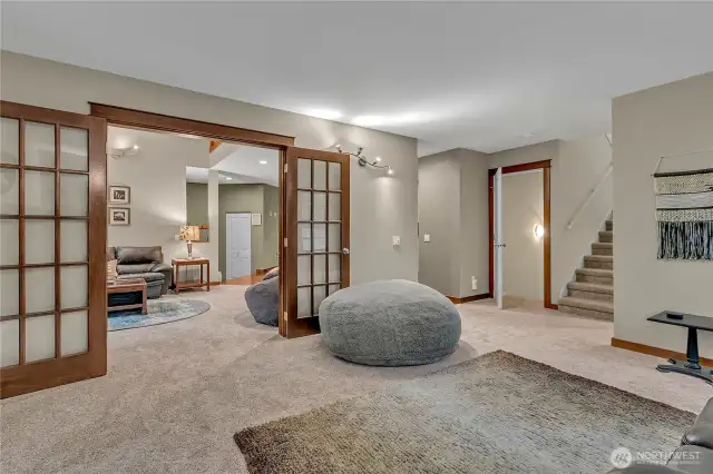 Here's another view from the family room to the living room. It's a wonderful circular floor plan offering many living areas to enjoy. The stairs to the right leads to the upper bedrooms. The open door will take you to the 994 sq. ft. garage which has a tremendous amount of storage or can be used as a game room too!