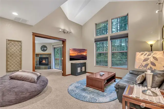 Look at those huge picture windows in the living room! Such a pretty view to the treed area and it offers much privacy too!