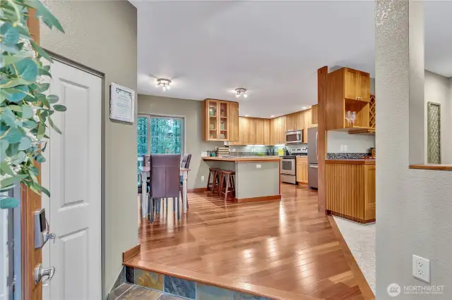 You are greeted by beautiful slate entry and the cherry wood flooring flows through the dining room and fully equipped kitchen. Notice the 'bar area' just to the right inside the living room.