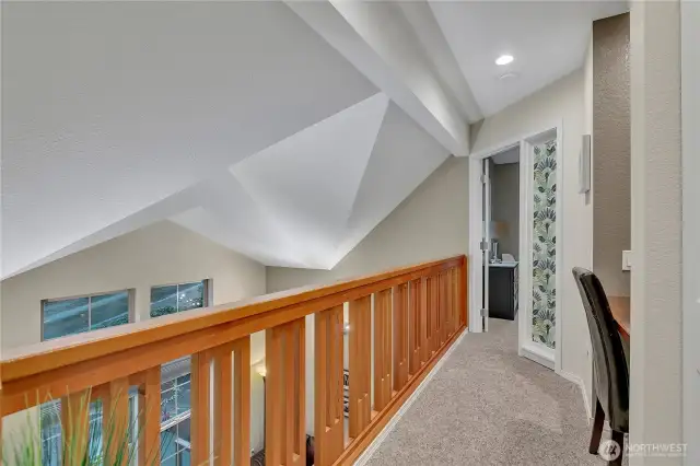 Beautiful custom railing on the 'sky-bridge' which looks onto the living room and front area. To the right is a desk area. It would make for a perfect work station.