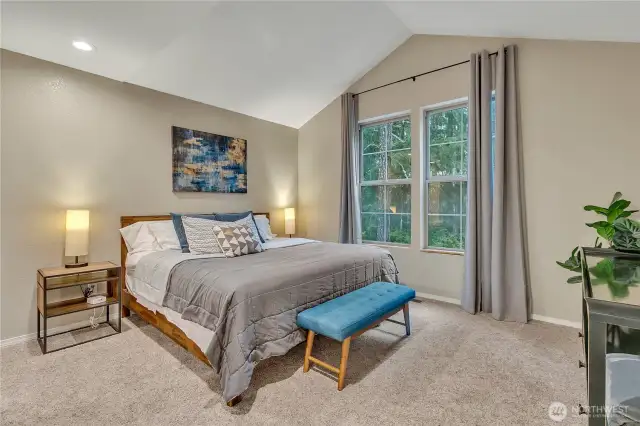 The large primary suite has vaulted ceilings and is located on the opposite side of the two secondary bedrooms---nice privacy!