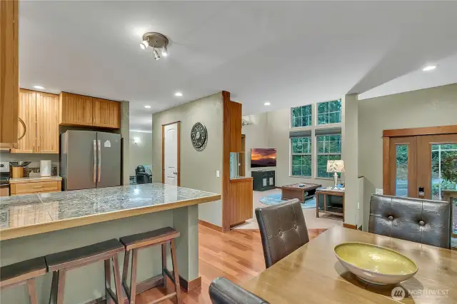 Here's the view from the dining room area into the living room. Look at all of the privacy! Beautiful treed areas all around.