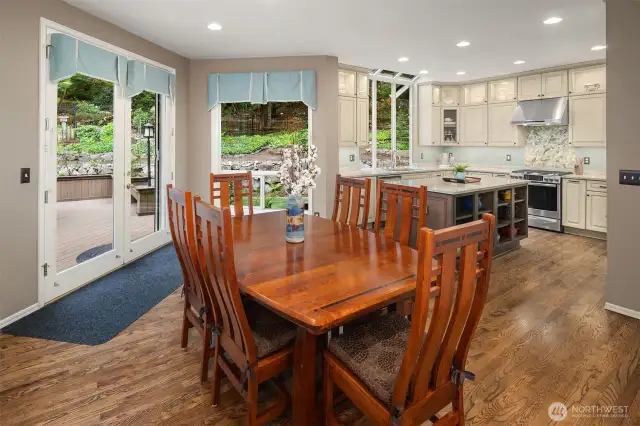 Casual dining area truly holds a full size dining room set. Notice the windows and French doors to the backyard,