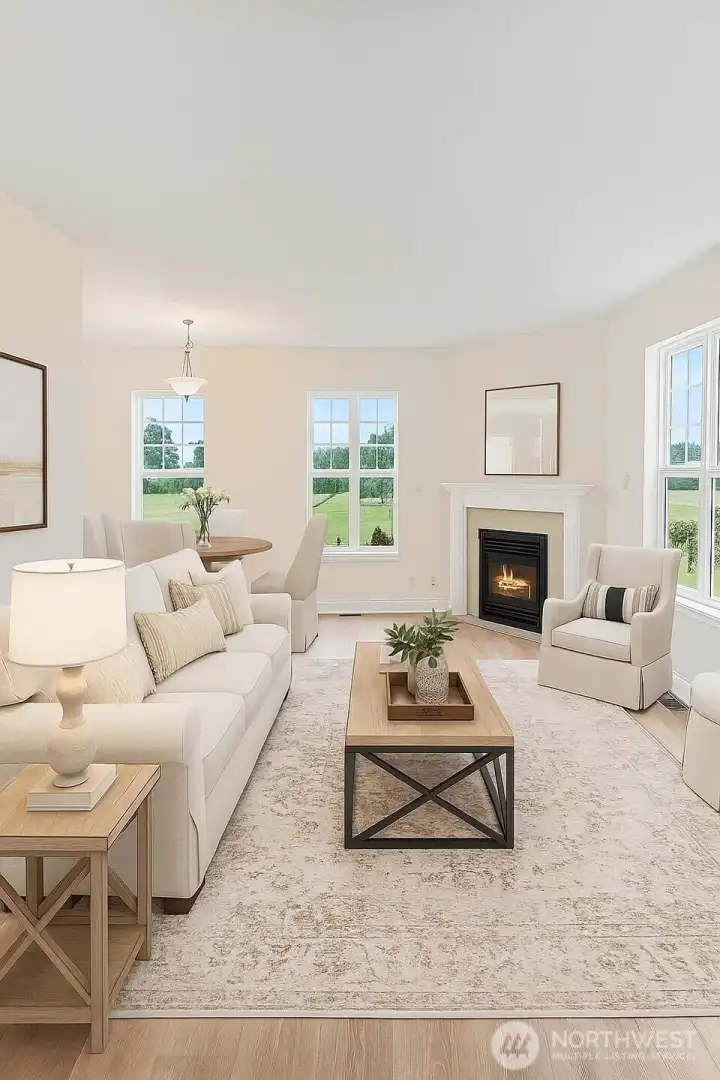 Virtually staged living room. A cozy gas fireplace, new LVP flooring, and beautiful views to the outdoors are the perfect backdrop for any decor of your choice.