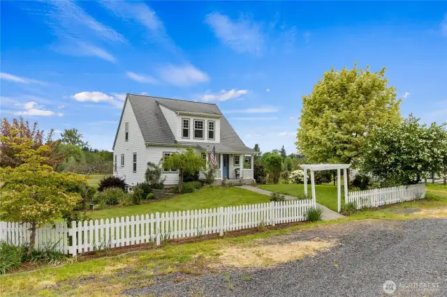 Immerse yourself in a country lifestyle  in this charming 2,240 sf home on 5 acres.  A paved walkway leads you from a pergola to a covered front porch, which adds to the timeless, pastoral charm. This property provides peaceful living but is  just minutes to I-5