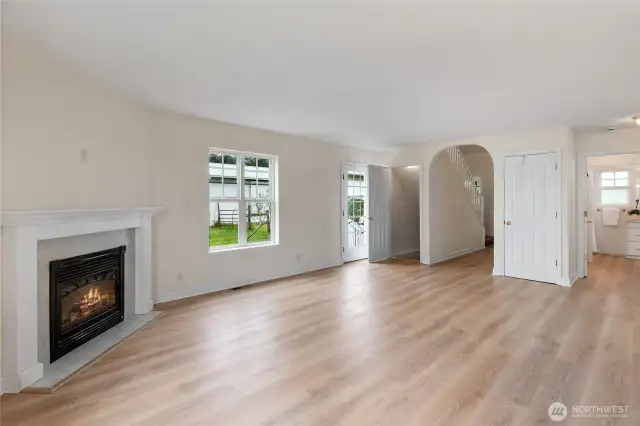 A neutral palette provides options to decorate however you like. The arched doorway leads to the front entry the open door to the left leads to the lower level & the glass door is a side entrance that leads to a patio and then barn.