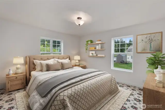 Virtually staged primary bedroom on main floor.  Primary bath is to the left.
