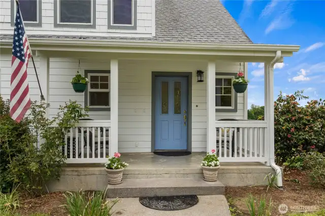 Quaint covered front porch welcomes you home & provides an inviting place to relax. Offering shelter and shade,  for moments of quiet reflection.