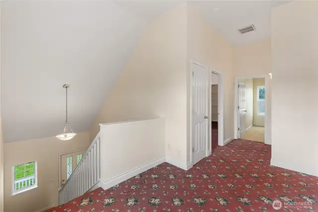 The upstairs landing looks down at the foyer. It's very open and has a lot of natural light coming in from the big windows. There is enough space to accommodate a small desk or reading nook.
