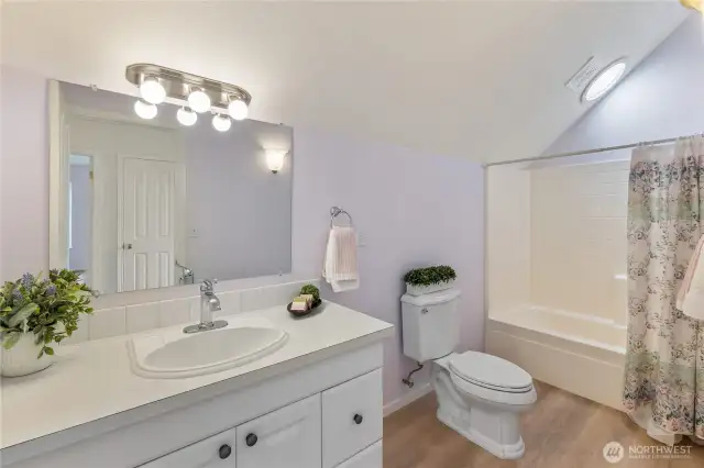 The second floor includes a full bath. This bathroom is a must-have for most households. It’s very spacious which is  also helpful if you’ve got lots of houseguests! The vaulted ceiling & solar tube are also desirable features.