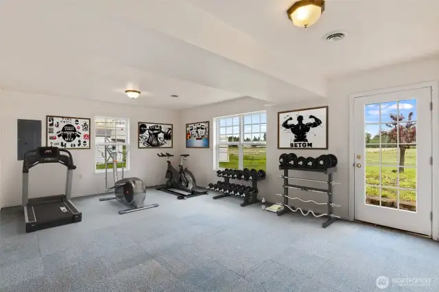 The lower level of the home houses this versatile, virtually staged bonus space.  It is a great area for a fitness studio, crafts or game room.
