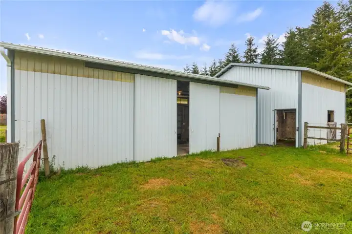 The two detached farm buildings on the eastside of the home include 5 stalls, a tack room, covered trailer/RV parking and/or shaving storage.