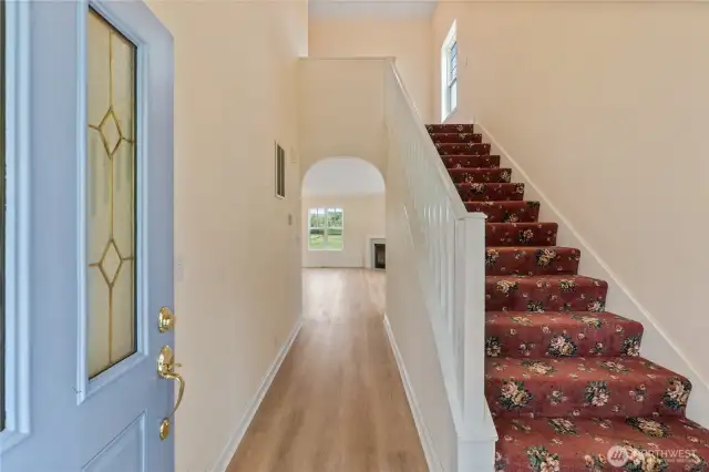 Welcoming 2-story foyer subtly invites you into the rest of the home.  An arched entrance provides a glimpse into the living room with a cozy gas fireplace. It’s a space that says, “Come in, take off your coat, and stay awhile.”  The stairwell leads to 2 additional bedrooms and a full bath on the second floor.