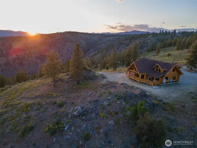 Exterior twilight side view of home overlooking Lake Chelan.