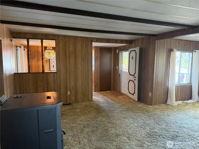 Family room facing front door and covered deck.