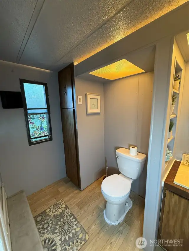 Linen and towel storage. Toilet across from shower.