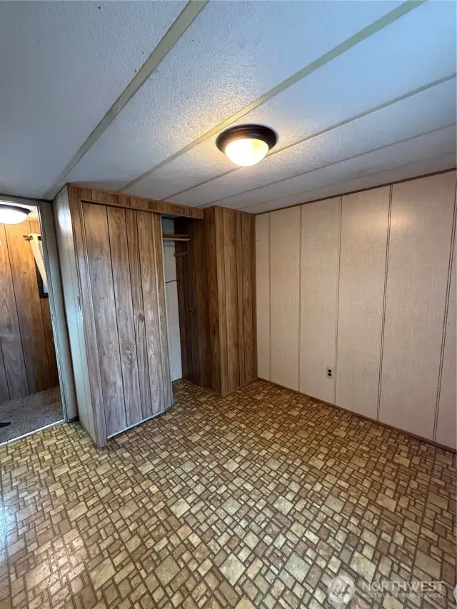 Extra bedroom with vinyl flooring and closet.