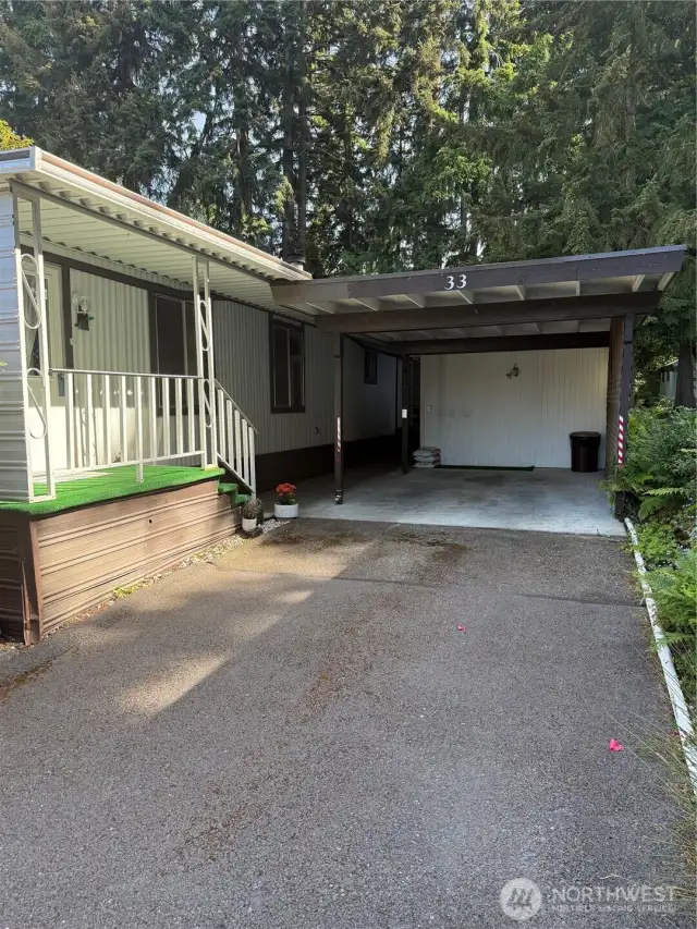 Full carport with storage shed.