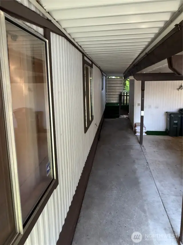 Back walkway to storage shed, back of the house covered porch and leads to the second storage shed.