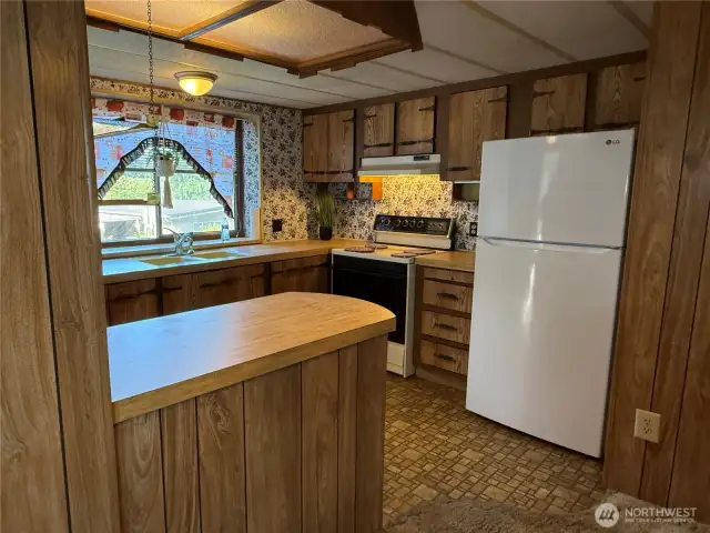 Breakfast bar fits stools underneath from inside kitchen side.