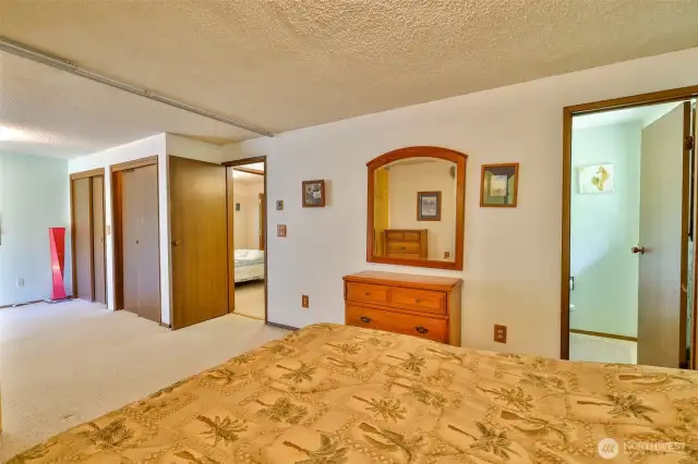 Primary Bedroom with 2 lighted closets and privacy curtain to allow access to the Sun Room and Back Yard.