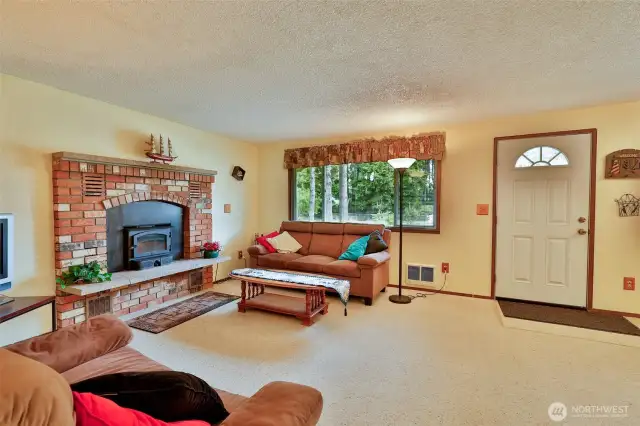 Cozy Living Room with wood burning fireplace.