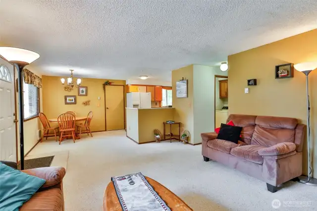 Living Room opens to the Dining and Kitchen.