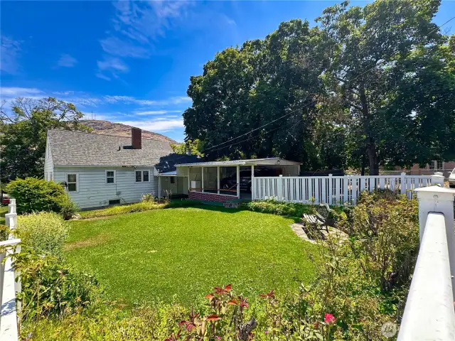 Vinyl fencing encloses backyard.