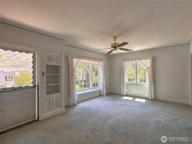 Entry and living room view. Fir flooring under carpet is standard throughout the local Cape Cod homes!