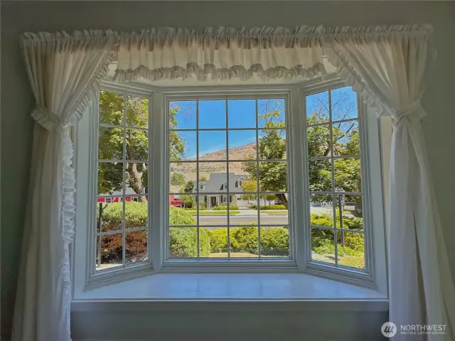 Charming bay window invites natural light and creates a cozy nook