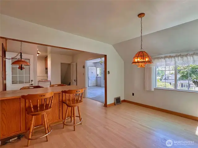 Dining room with breakfast bar seating gives extra storage space & separates from kitchen area.