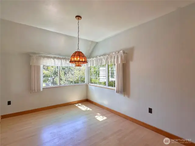 Corner windows fill the room with natural light, creating a bright and airy atmosphere.