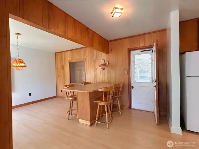 Back door leads to covered patio, fenced back yard, and carport.