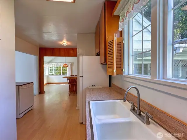 Kitchen view towards bar seating area and dining room.