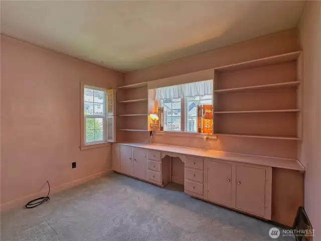 Bedroom 2 of 2 on main floor with built-in wall unit.
