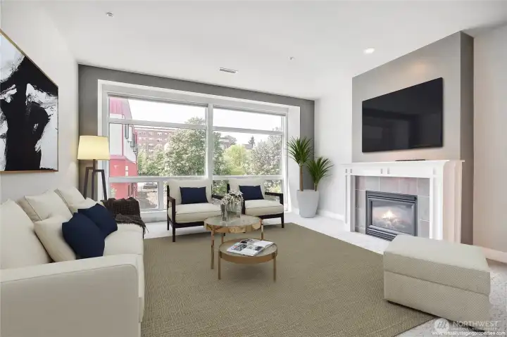 The living room is enhanced by floor-to ceiling-windows that flood the space with natural light.