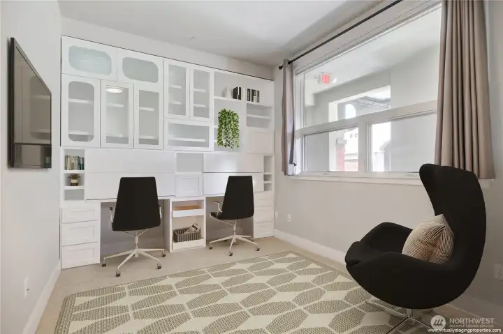 2nd/Guest Bedroom is equipped with a built-in desk and plenty of storage space for a home office.