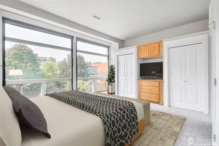 Spacious Primary Bedroom including two closets and floor to ceiling windows with blackout shades for a cozy night of sleep.