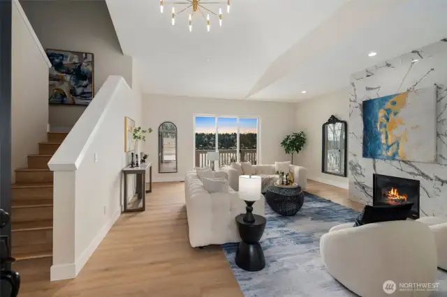 Well lit living room high ceilings.