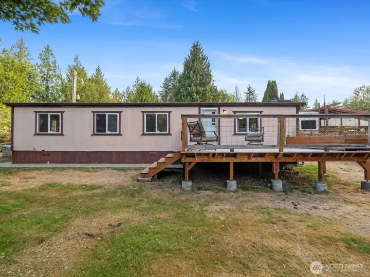 Rear of the building features a deck overlooking the private backyard.