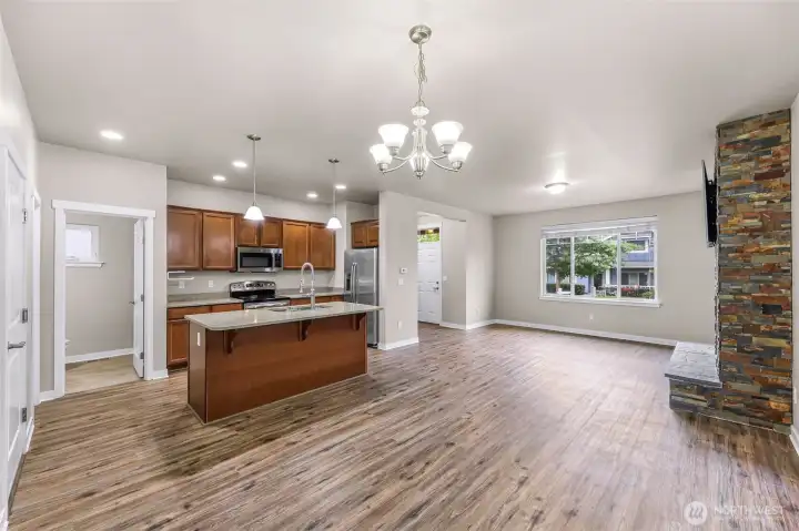 Looking from the dining area towards the living room, kitchen and powder room