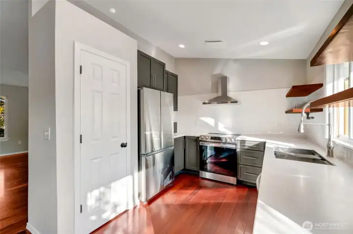 Complete with a pantry, newer stainless steel appliances, and views stretching out to the picturesque backyard.