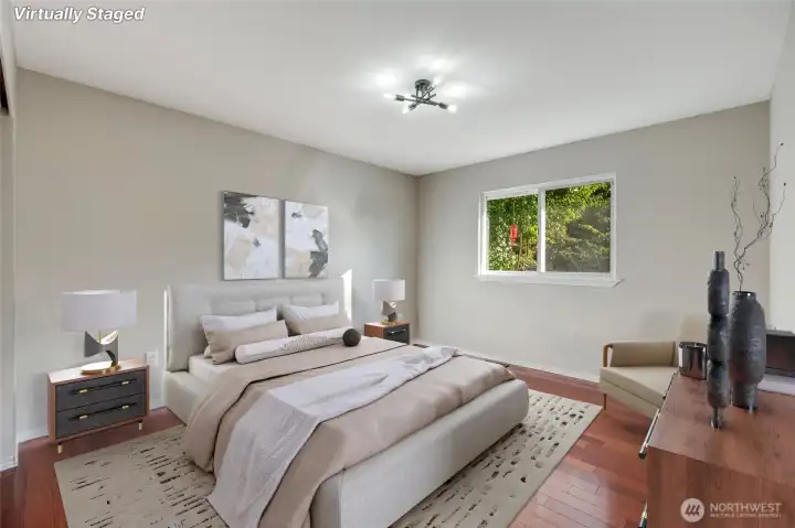 Tucked away for quiet relaxation, the spacious primary bedroom offers a restful retreat at the end of the day.