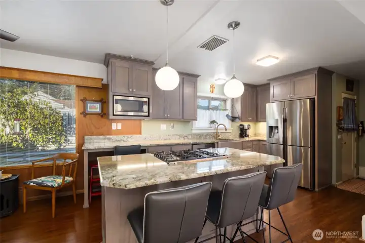 The updated kitchen has lots of space & granite countertops