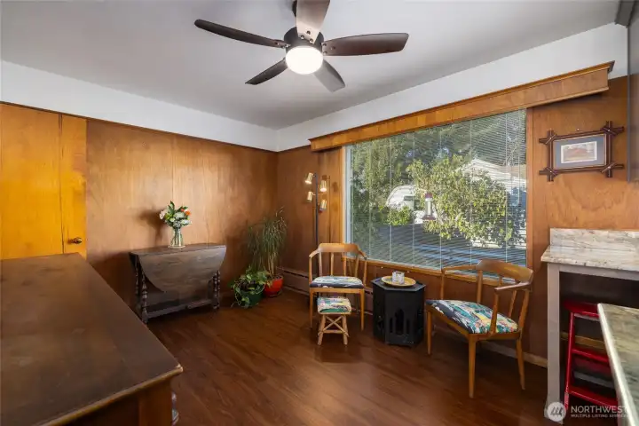 The den has wood paneling & a upper cabinet w/glass doors.