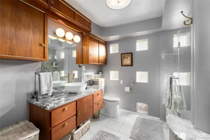 The bathroom is light filled with the refinished cast iron tub/shower.
